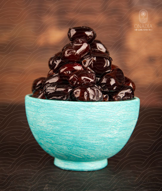 blue bowl full of mazafati dates