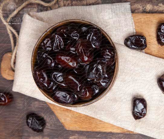 a bowl of mazafati dates on a white cloth